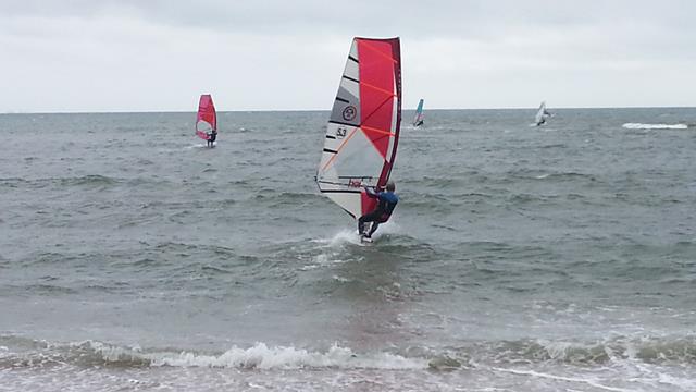 windsurfers on the sea windy cloudy day choppy sea