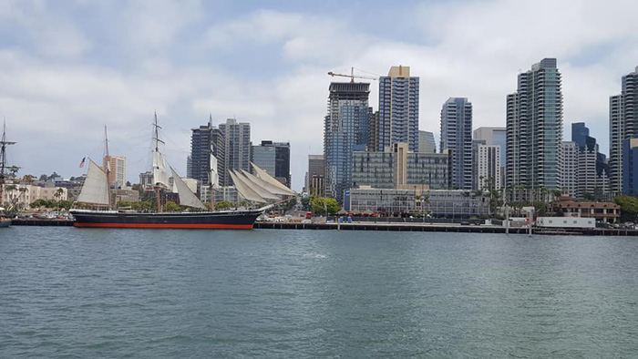 old ship in front of San Diego City skyline