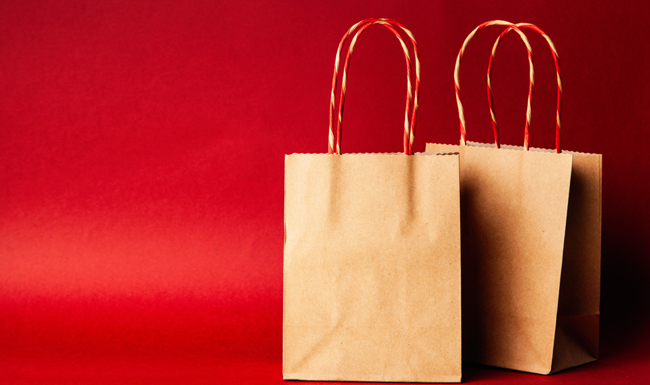 two brown paper bags with red and white striped handles eco friendly and zero waste gift ideas and wrapping